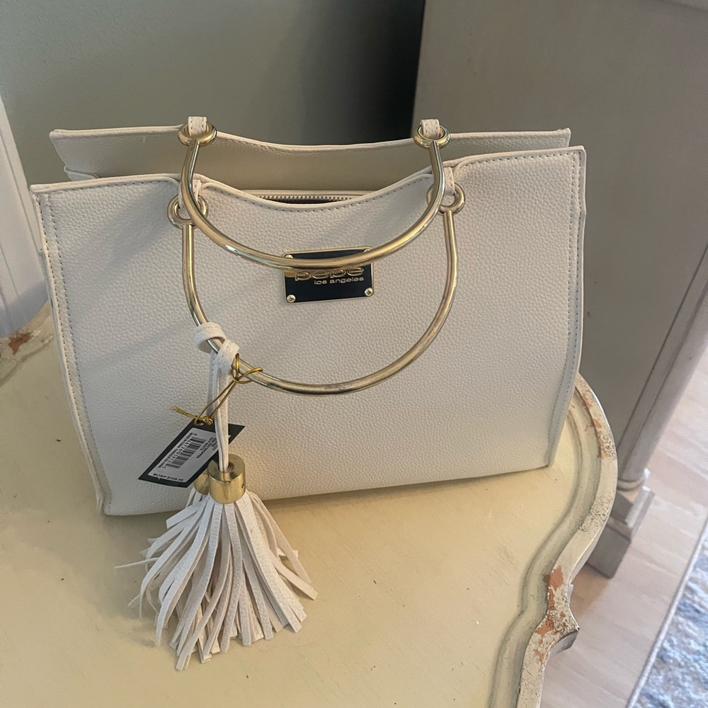 Beautiful Off White handbag with gold handles.